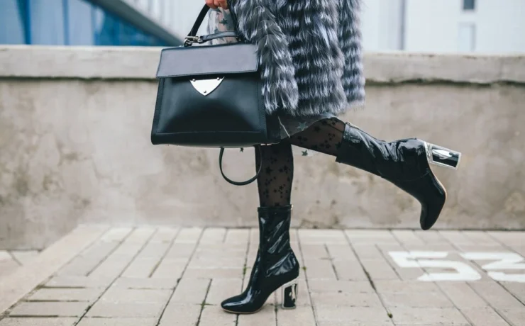 close-up-accessories-details-stylish-woman-walking-city-warm-fur-coat-winter-season-cold-weather-holding-leather-handbag-legs-boots-footwear-street-fashion-trend-large